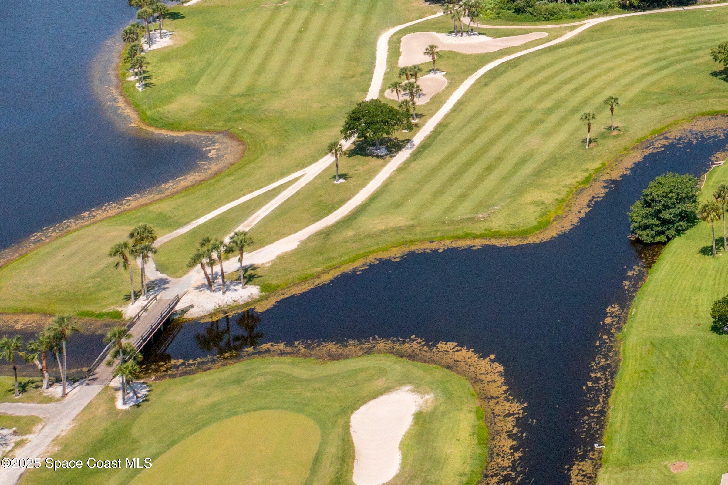 4048 Sand Ridge Drive Merritt Island, FL 32953 - Photo 56 of 70 a blue swimming pool with a yard and seating area