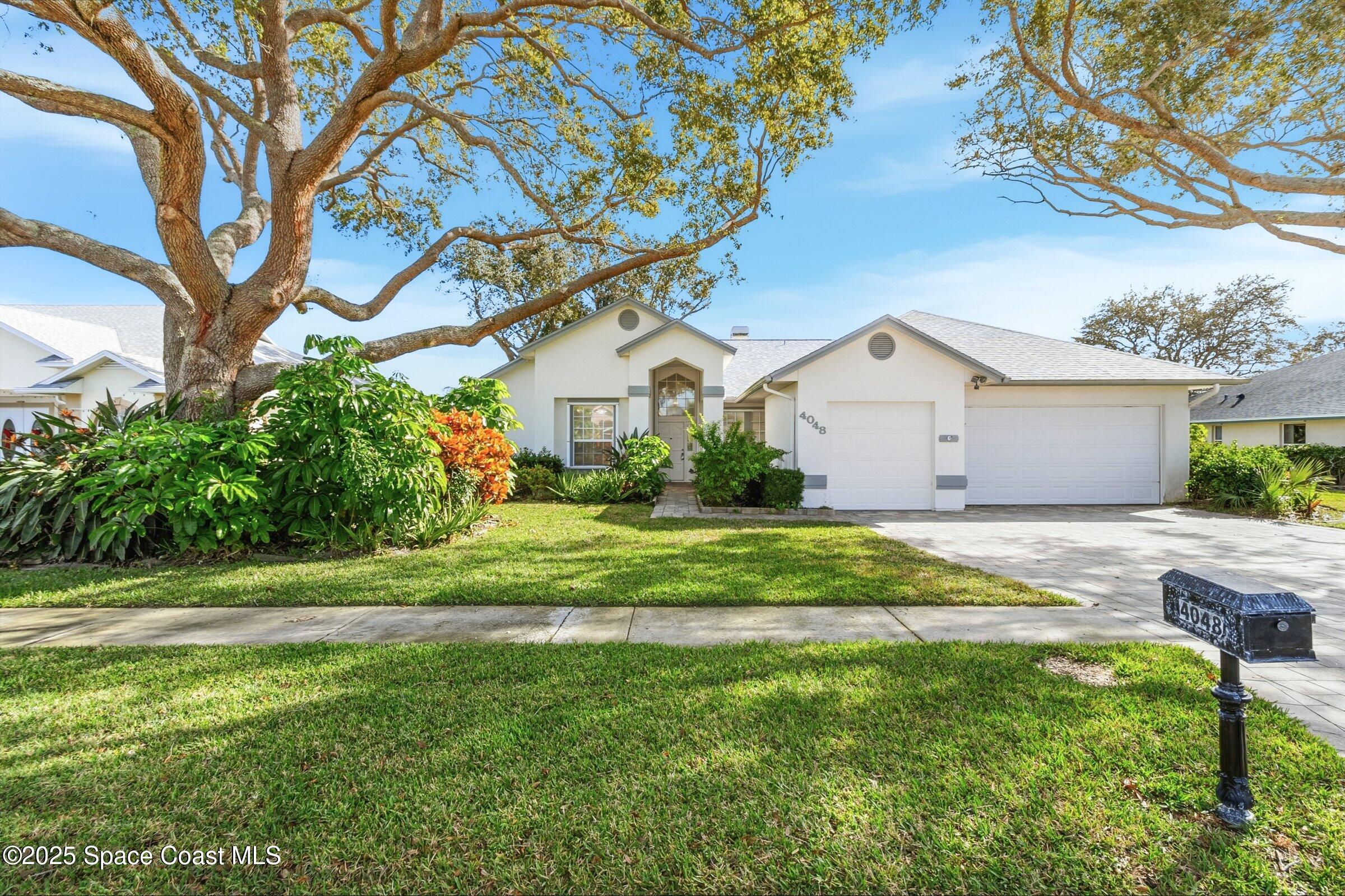 4048 Sand Ridge Drive Merritt Island, FL 32953 - Photo 6 of 70 a front view of a house with garden