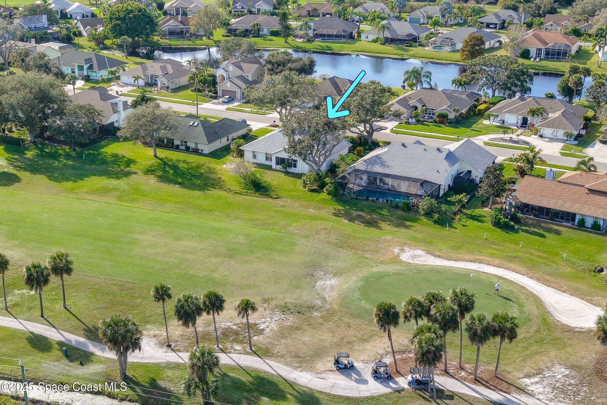 4048 Sand Ridge Drive Merritt Island, FL 32953 - Photo 63 of 70 an aerial view of residential houses with outdoor space and lake view