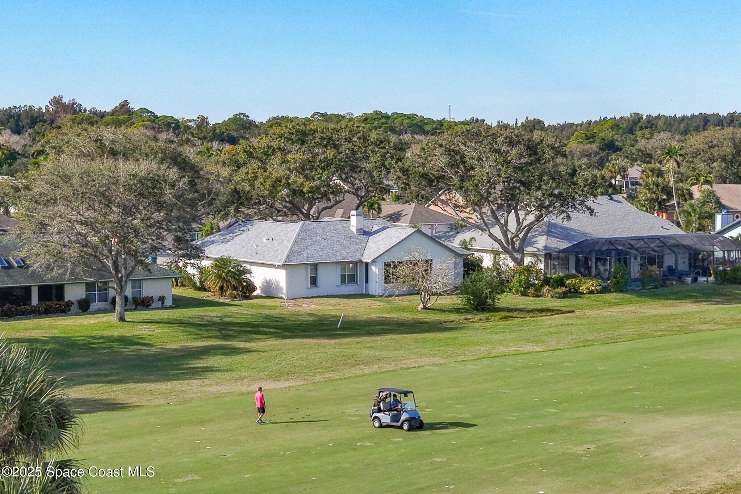 4048 Sand Ridge Drive Merritt Island, FL 32953 - Photo 65 of 70 a front view of a house with a yard