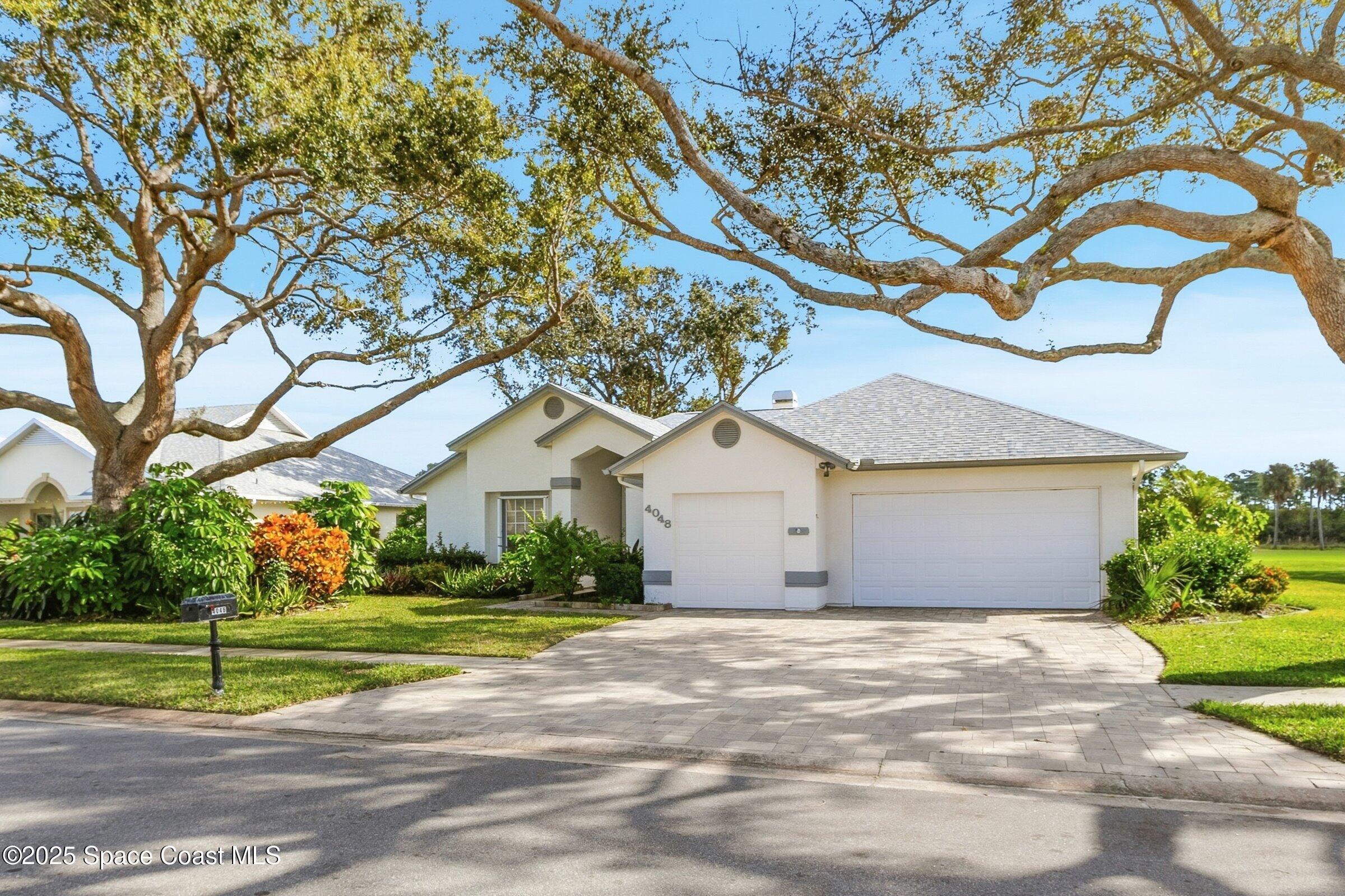 4048 Sand Ridge Drive Merritt Island, FL 32953 - Photo 7 of 70 a front view of a house with a yard and garage