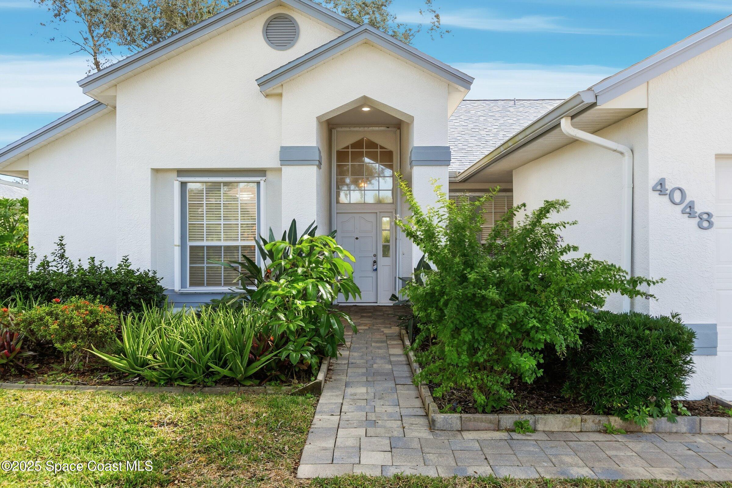 4048 Sand Ridge Drive Merritt Island, FL 32953 - Photo 8 of 70 a front view of a house with garden