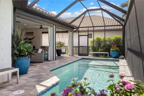 a swimming pool with patio outdoor seating and yard