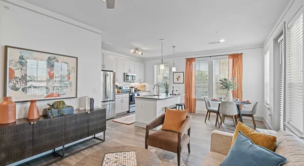 a living room with furniture and large windows