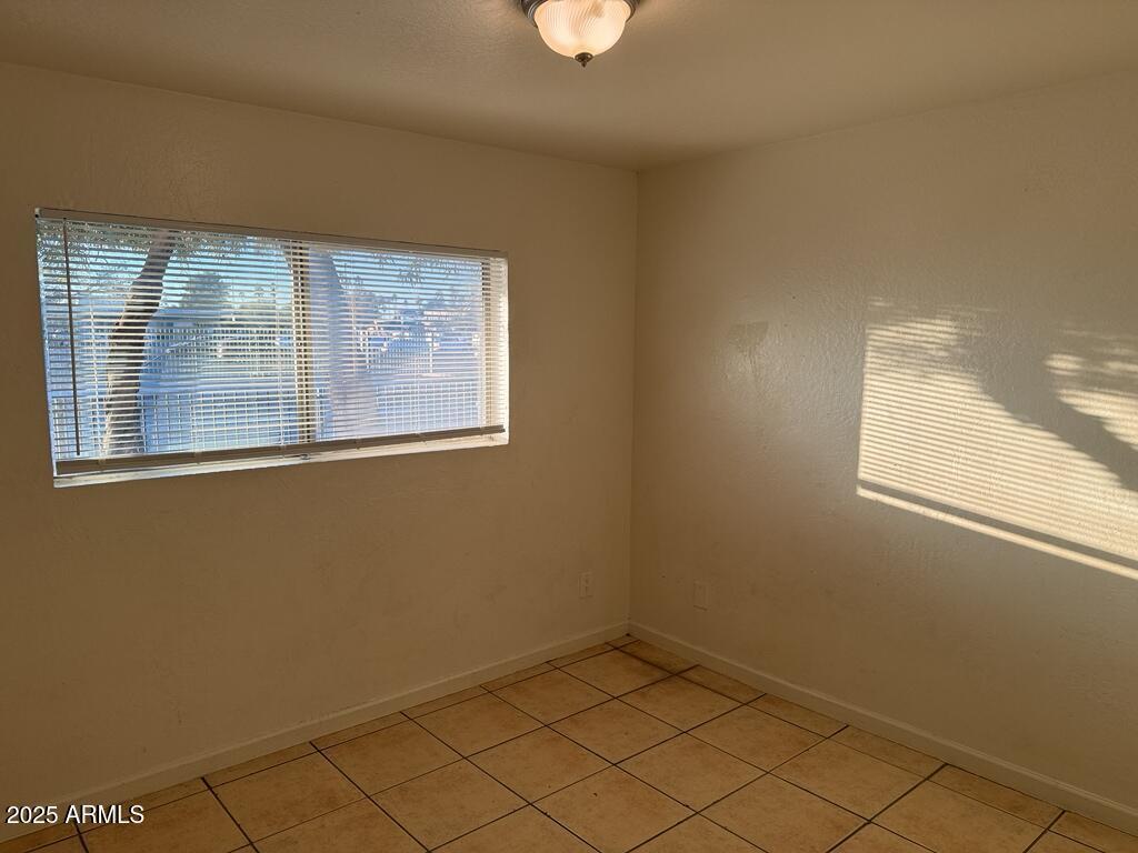 4829 North 37th Avenue, Unit 1 Phoenix, AZ 85019 - Photo 3 of 9 a view of an empty room with a window