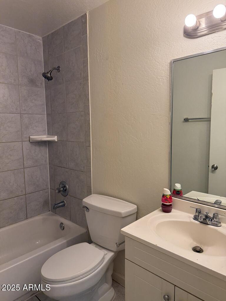 4829 North 37th Avenue, Unit 1 Phoenix, AZ 85019 - Photo 9 of 10 a bathroom with a sink a toilet and shower