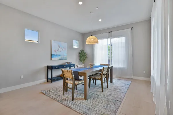 a view of a dining room with furniture and window