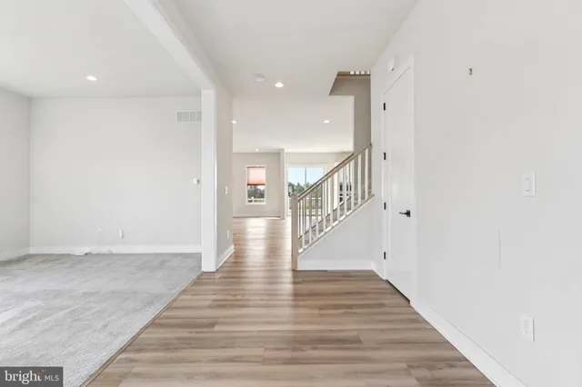 a living room with fireplace furniture and a wooden floor