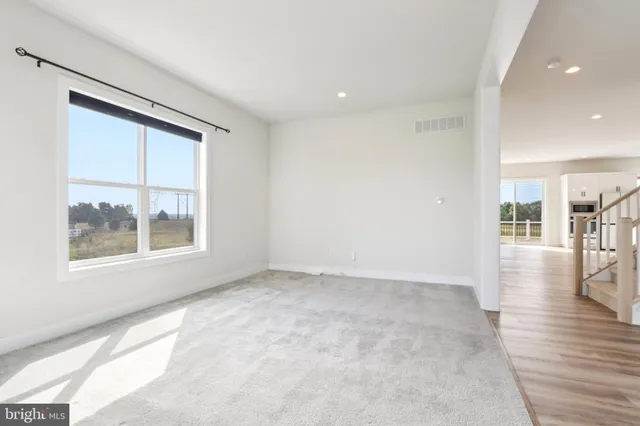 a large kitchen with stainless steel appliances lots of counter space and wooden floor