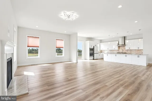 a kitchen with a dining table chairs stove microwave and cabinets