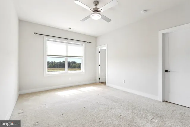 a living room with furniture a flat screen tv and a rug