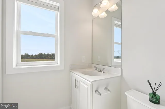 a view of a hallway with wooden floor and entryway