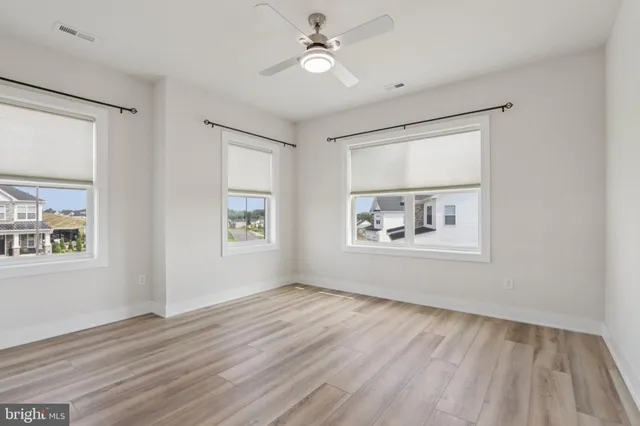 a white building with a big yard and more windows
