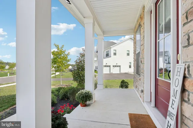 a view of a hallway view with wooden floor and staircase