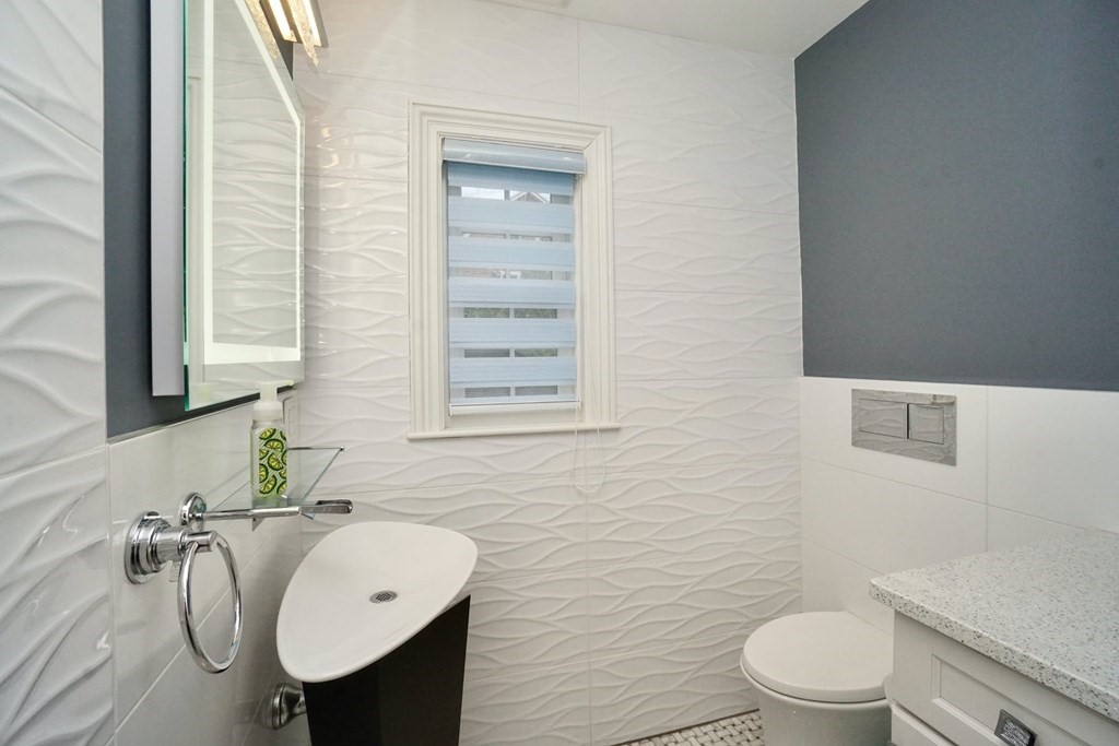 725 Chestnut Street Newton, MA 02468 - Photo 13 of 42 a bathroom with a sink toilet and mirror