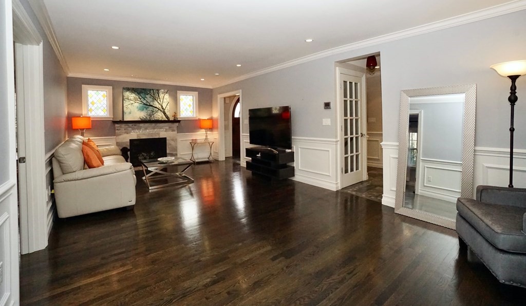 725 Chestnut Street Newton, MA 02468 - Photo 7 of 42 a living room with furniture flat screen tv and a fireplace