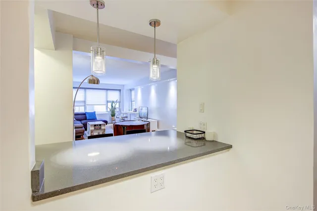 a living room with furniture and a ceiling fan