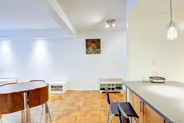 a hallway with a table and chairs