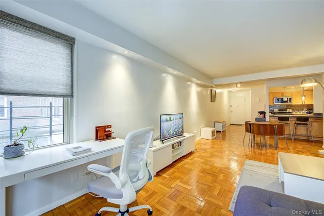 a living room with furniture and view of kitchen