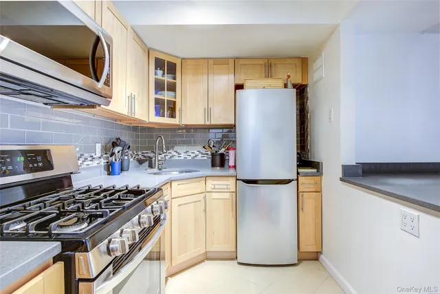 a kitchen with a refrigerator stove and sink