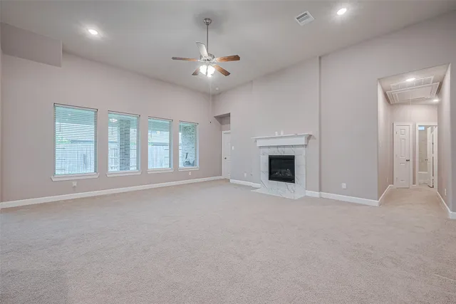 a large kitchen with kitchen island a sink a stove a oven with white cabinets