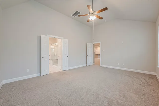 a spacious bathroom with a tub sink and mirror