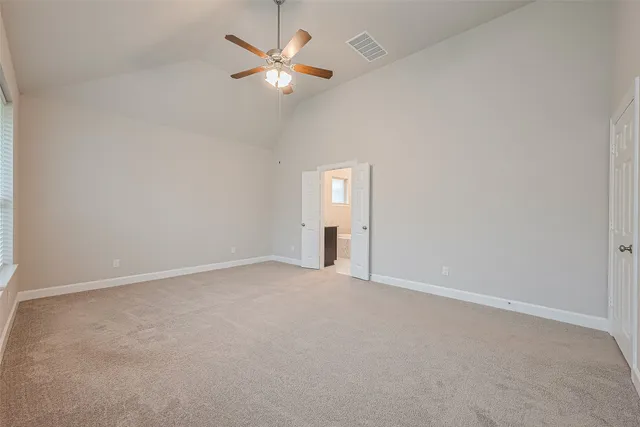 a large bathroom with a granite countertop sink a toilet a mirror and shower