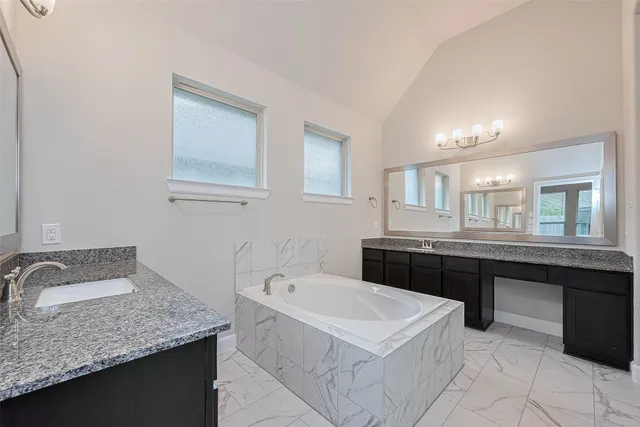 a large bathroom with a double vanity sink a large mirror and shower