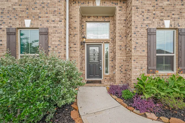 front view of a brick house with a large window