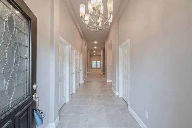 a view of a hallway with a chandelier