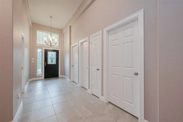 a view of a hallway with windows and brick walls