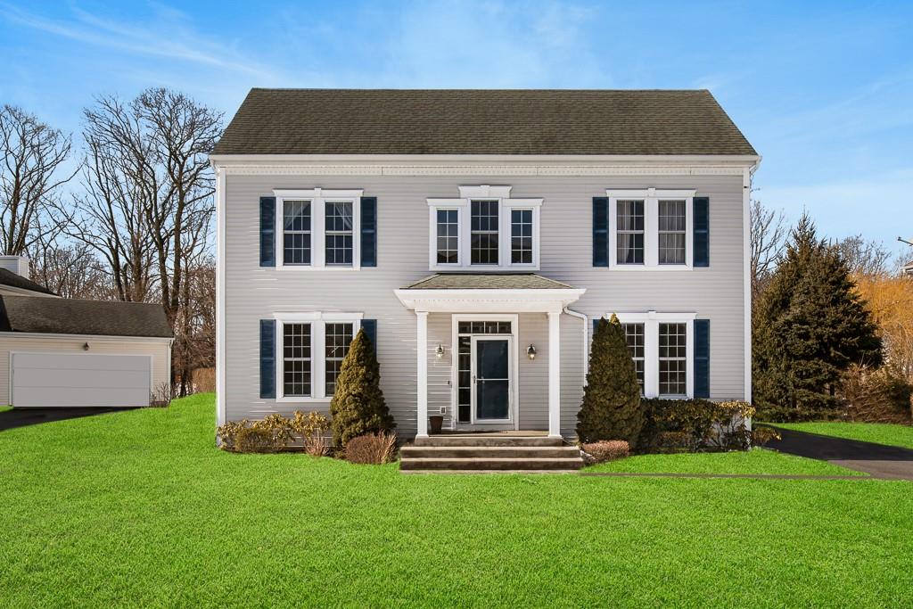 a front view of a house with a garden and yard