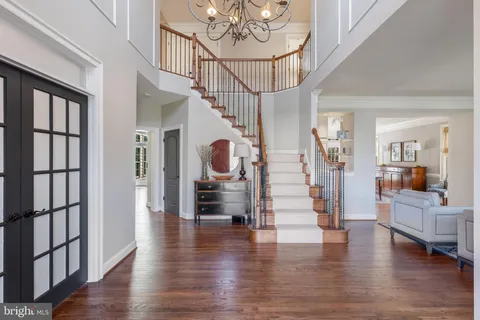 a view of a dining room with furniture wooden floor and a chandelier