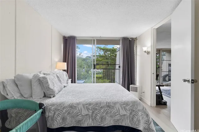 a bedroom with a bed and a large window