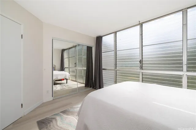 a bedroom with a large bed and a large window