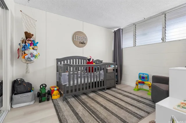 a bedroom with furniture and a book shelf