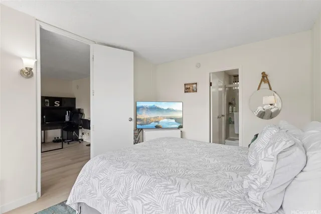 a bedroom with a bed and a chair