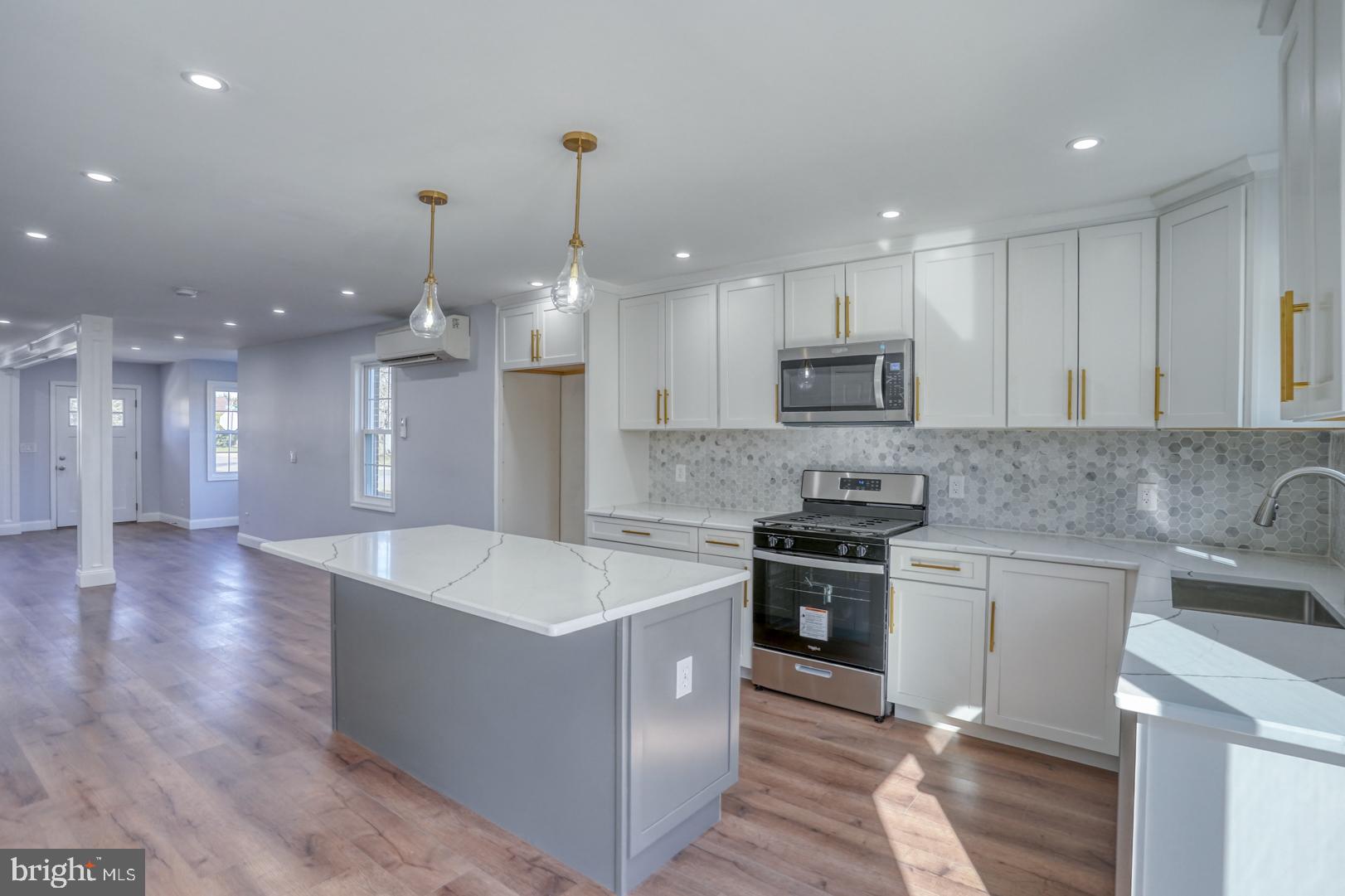 613 Taylor Street Townsend, DE 19734 - Photo 1 of 36 a large kitchen with stainless steel appliances kitchen island a large counter top a sink and a stove