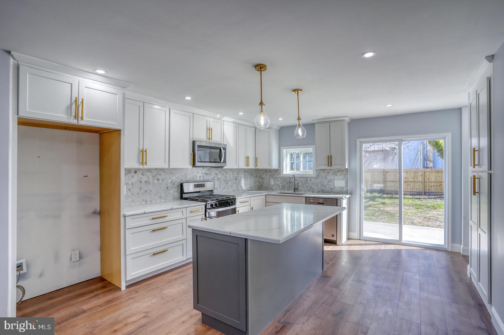 613 Taylor Street Townsend, DE 19734 - Photo 14 of 36 a kitchen with kitchen island a sink stainless steel appliances and cabinets