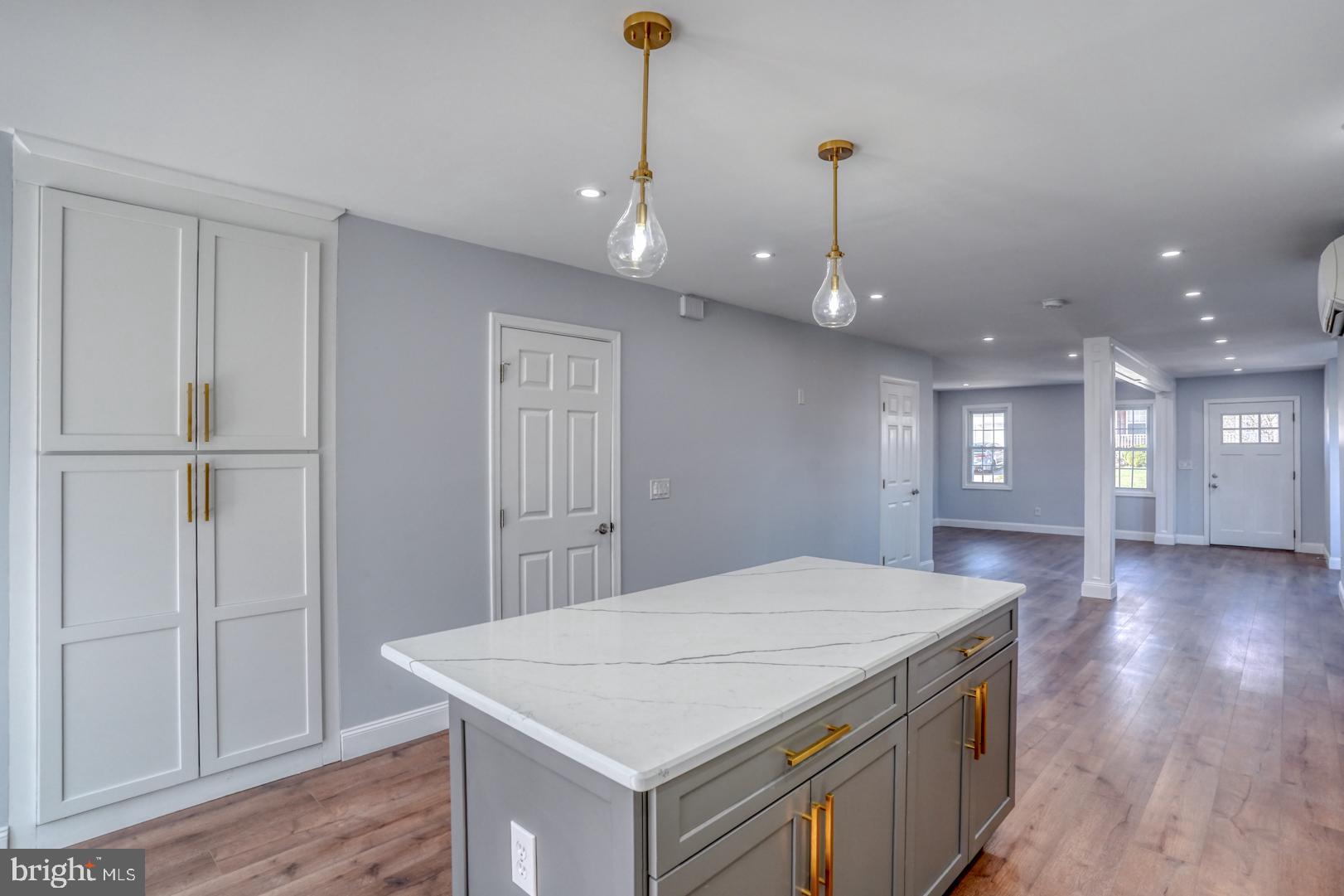 613 Taylor Street Townsend, DE 19734 - Photo 16 of 36 a kitchen with kitchen island a sink stainless steel appliances and wooden floor