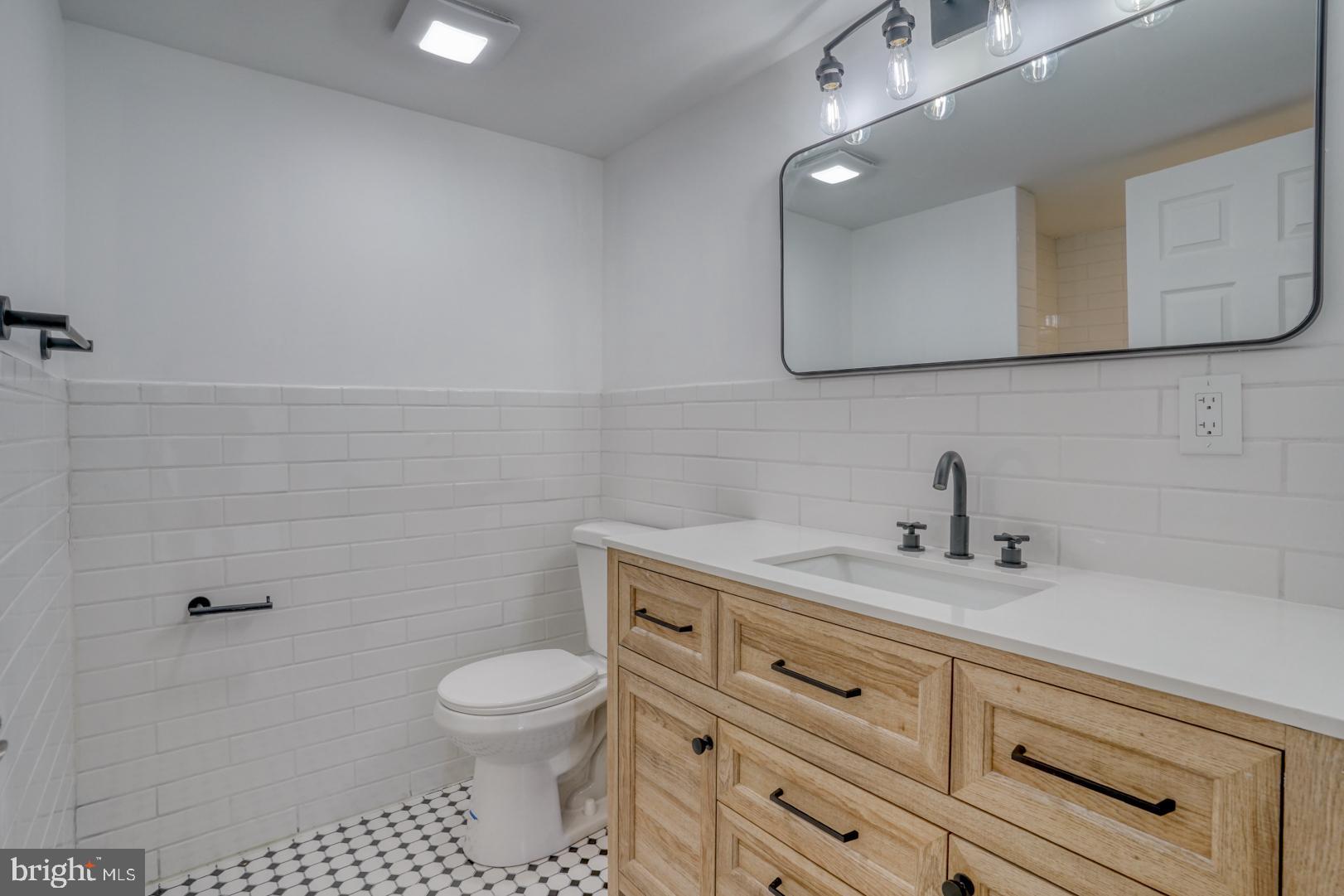 613 Taylor Street Townsend, DE 19734 - Photo 24 of 36 a bathroom with a granite countertop toilet sink mirror and vanity