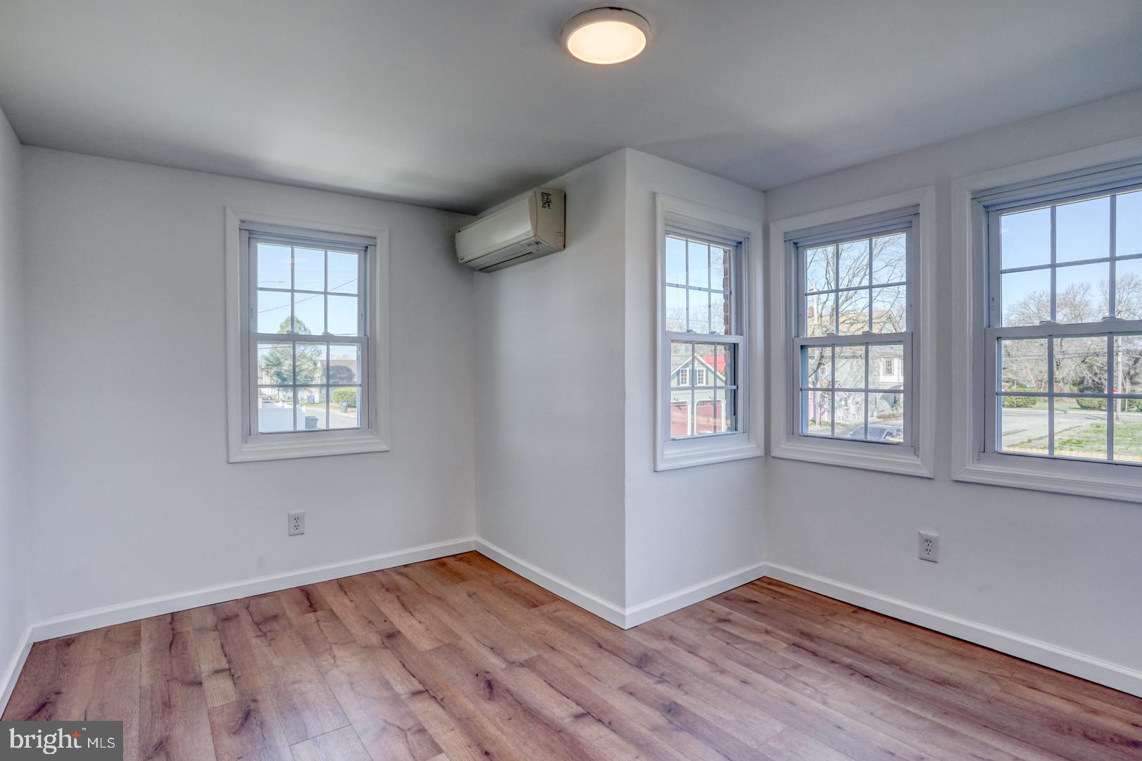 613 Taylor Street Townsend, DE 19734 - Photo 27 of 36 an empty room with wooden floor and windows
