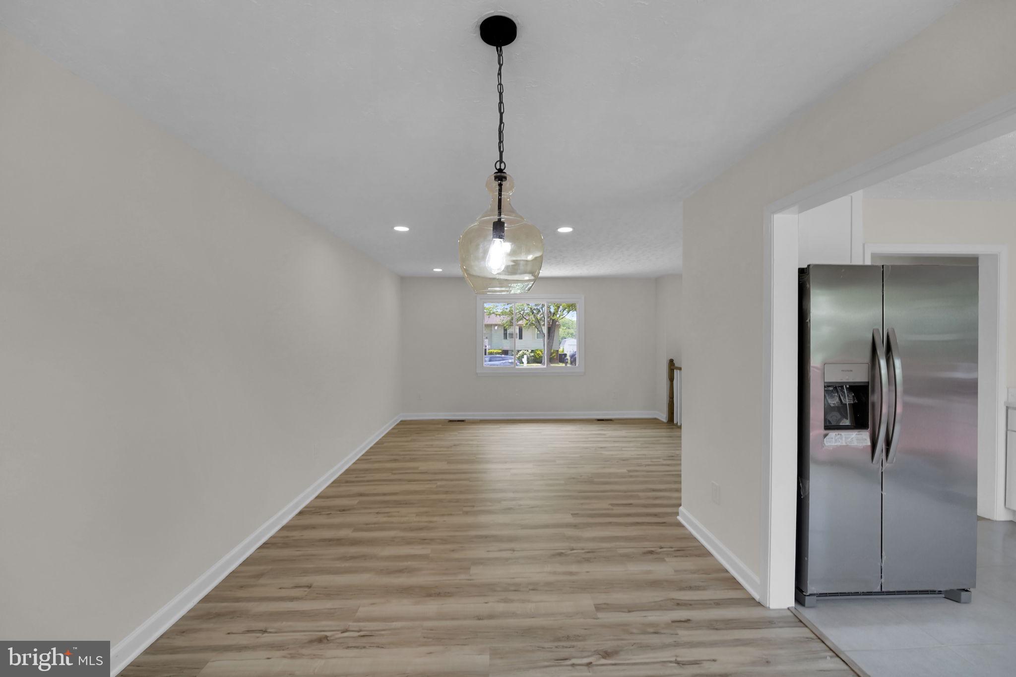 8613 Weems Road Manassas, VA 20110 - Photo 2 of 50 a view of an empty room with window and wooden floor