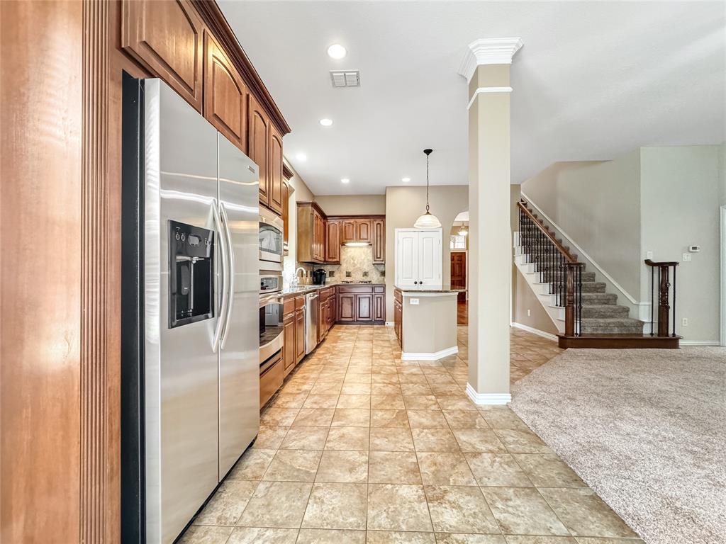 401 Varnum Way Fairview, TX 75069 - Photo 6 of 33 a view of a kitchen with refrigerator and a stove