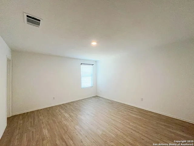 a view of an empty room and wooden floor