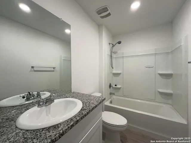 a bathroom with a sink a toilet and a bathtub
