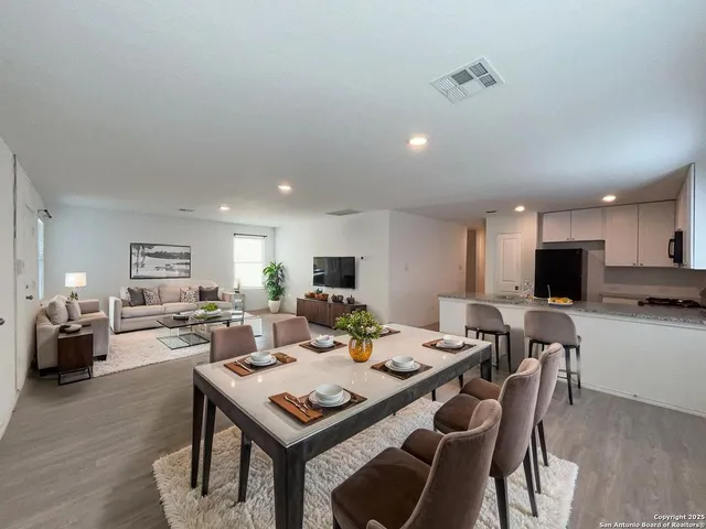 a view of a dining room with furniture and wooden floor