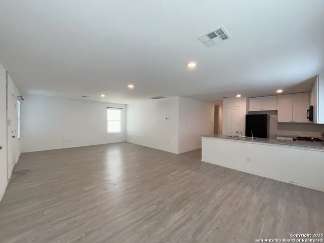 a view of kitchen with sink and natural light