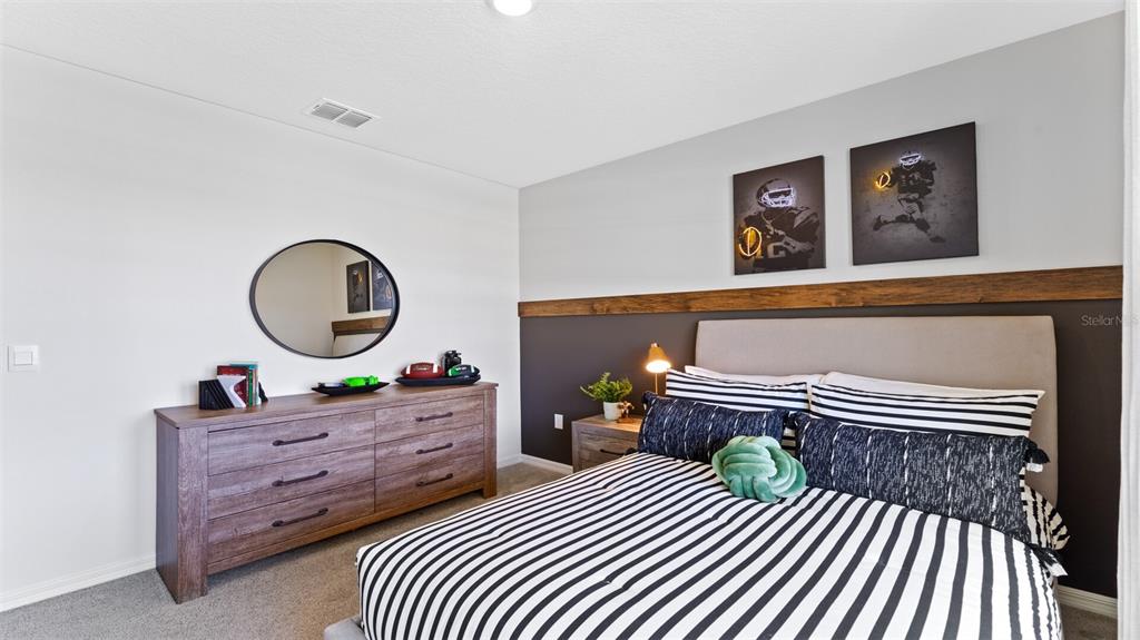 5221 Masser Road St. Cloud, FL 34772 - Photo 27 of 39 a bedroom with a bed and a dresser