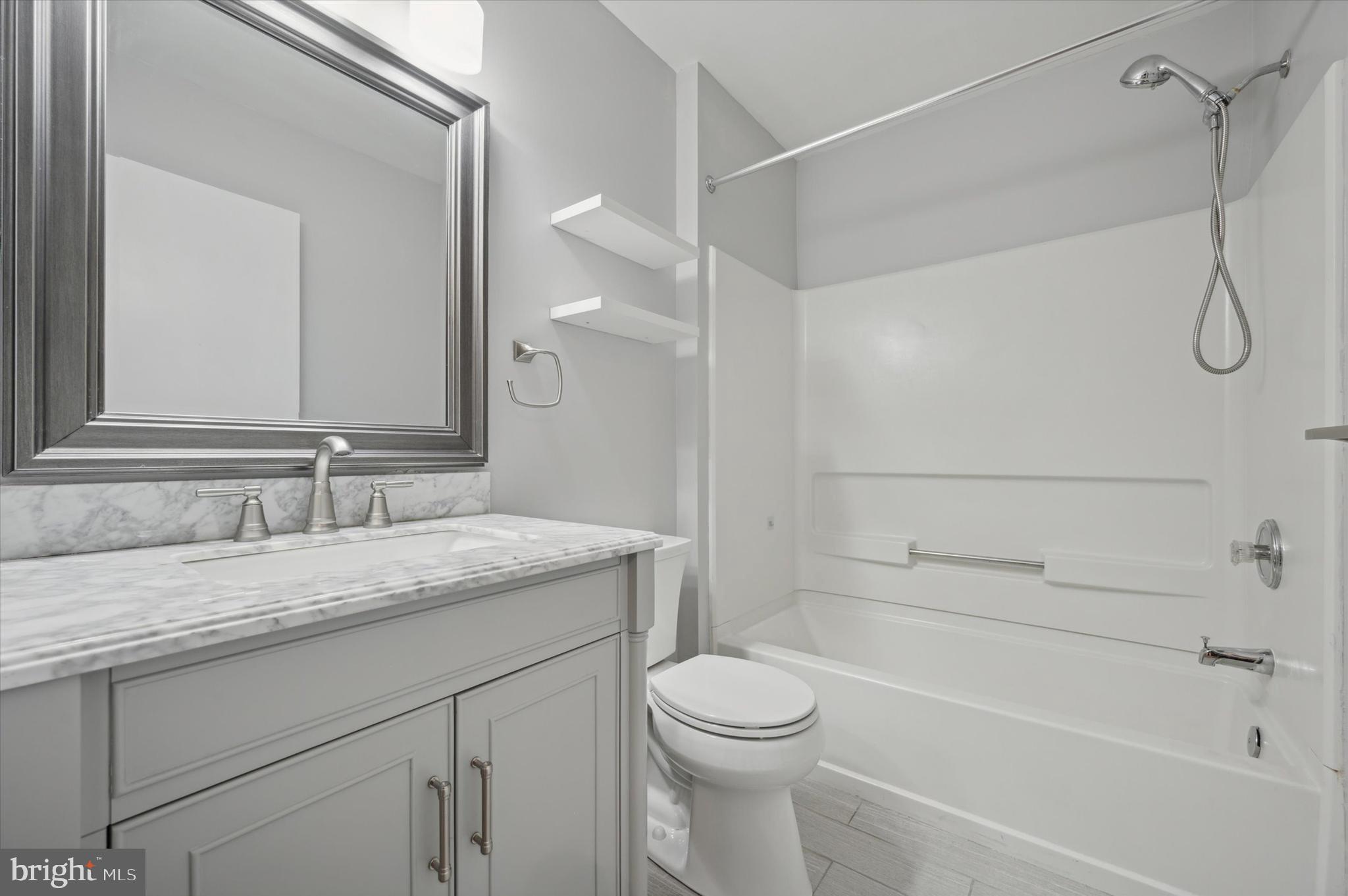 9 Meadow Lane Delran, NJ 08075 - Photo 11 of 15 a bathroom with a granite countertop sink a toilet and shower
